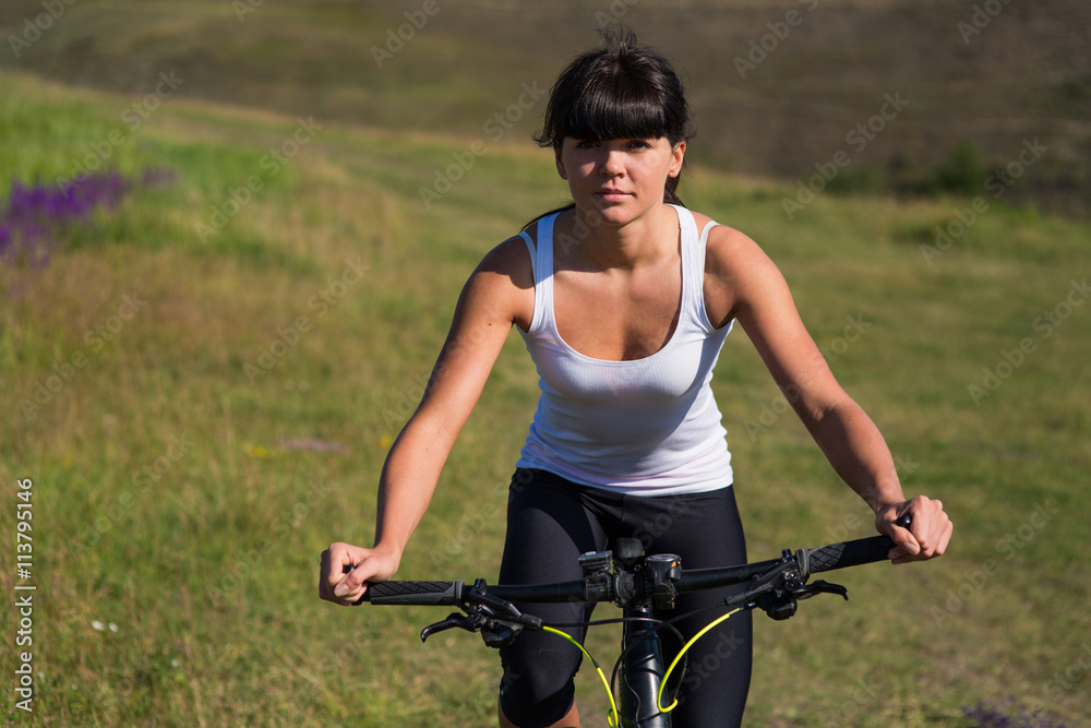 woman going for bike ride on sunny day in countryside woman going for bike ride on sunny day in countryside