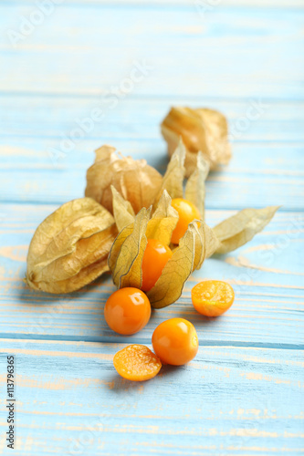 Ripe physalis on a blue wooden table