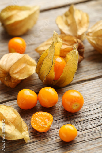 Ripe physalis on a grey wooden table photo