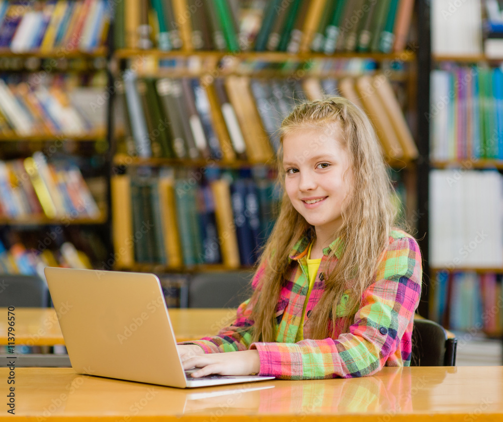 girl with laptop in library girl with laptop in library