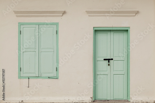 old window and door on color wall thai style, vintage tone class © panya99