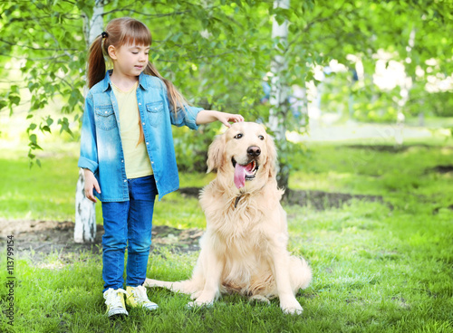Little girl and big kind dog in the park
