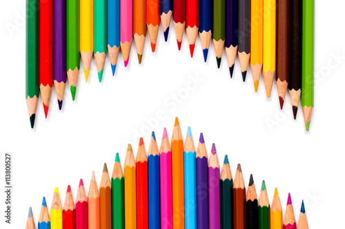 Row of color pencil placed on white background
