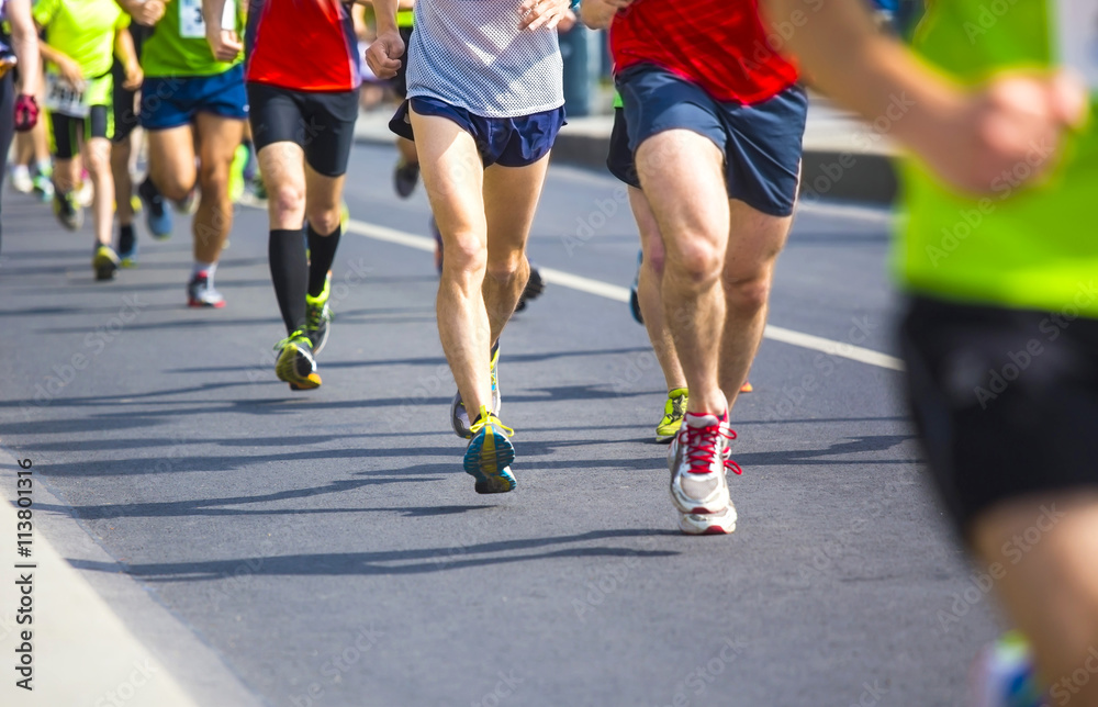 marathon runners with their shadows running on the street marathon runners with their shadows running on the street