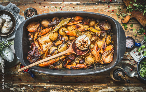 Canvas Print Stew with roasted vegetables, forest mushrooms and wild hunting fowl in cooking pot with wooden spoon