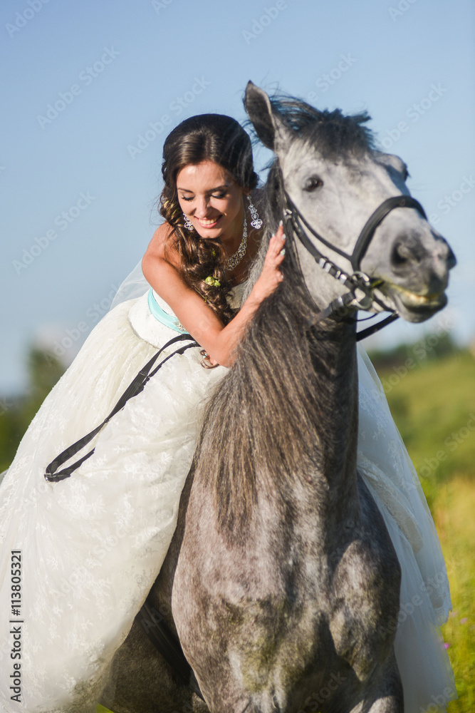 Fototapeta premium Young happy smiling woman with horse