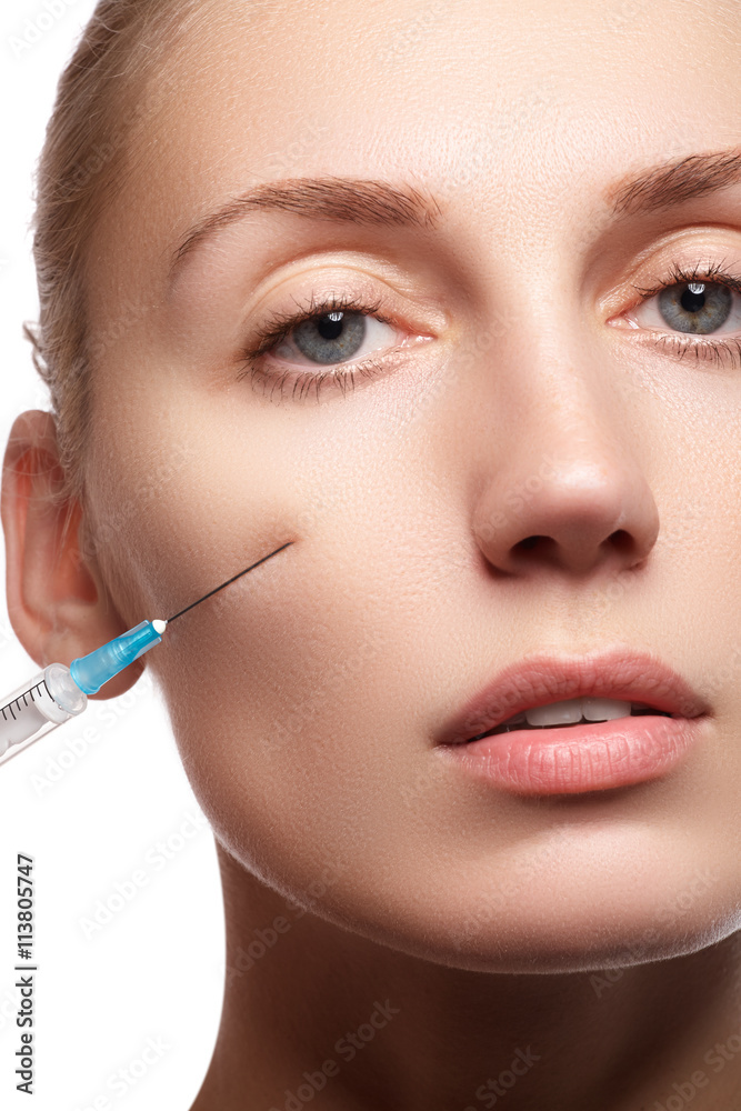 Portrait of young woman getting cosmetic injection. Closeup of beautiful woman gets injection in her face. Filler injections. Lip augmentation. Beautiful perfect lips Portrait of young woman getting cosmetic injection. Closeup of beautiful woman gets injection in her face. Filler injections. Lip augmentation. Beautiful perfect lips