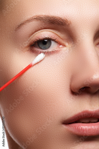 Skin care woman removing face makeup with cotton swab. Skin care concept. Caucasian model with perfect skin. Beauty & Spa.

 photo