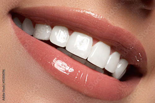 Macro happy woman's smile with healthy white teeth.Lips make-up photo