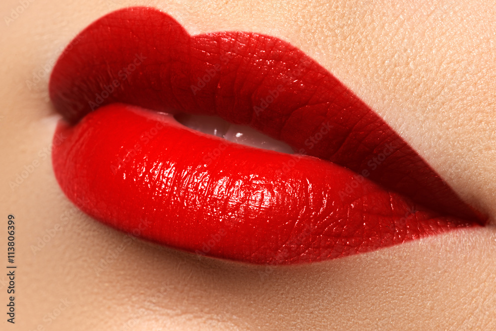 Obraz premium Close-up shot of woman lips with red lipstick. Beautiful perfect lips. Sexy mouth close up. Beautiful wide smile of young fresh woman with full lips