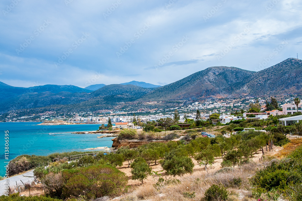 Panorama of Hersonissos town in Crete, Greece and mountains