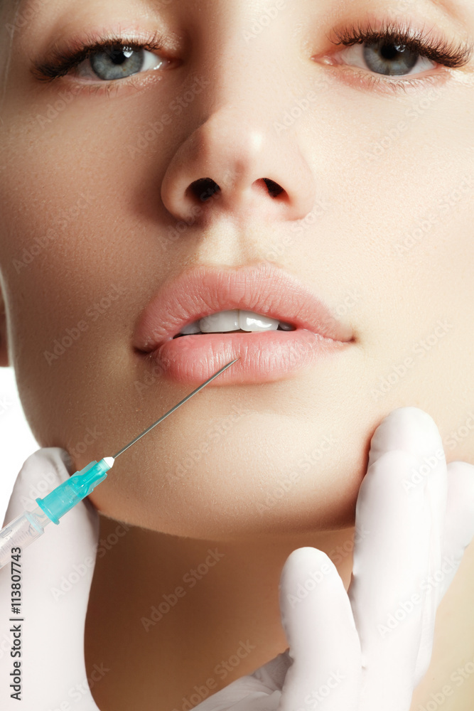 Portrait of young  woman getting cosmetic injection