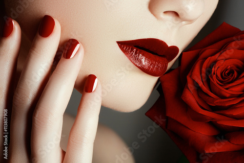 Beauty fashion model woman face. Portrait with red rose flower