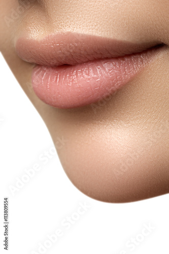 Close-up of woman's lips with fashion natural beige lipstick make-up