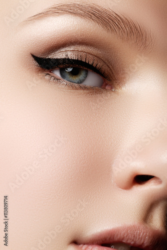 Cosmetics & make-up. Beautiful female eye with sexy black liner Fototapet