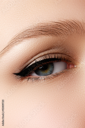 Fototapeta Naklejka Na Ścianę i Meble -  Cosmetics & make-up. Beautiful female eye with sexy black liner