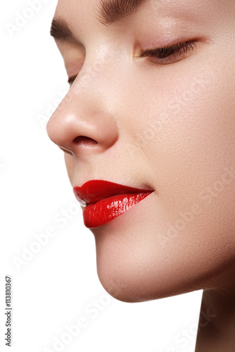 Close-up shot of woman lips with red lipstick. Beautiful perfect make-up