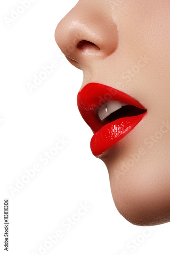 Close-up shot of woman lips with glossy red lipstick. Professional make-up
