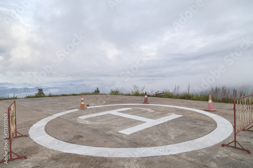 helicopter park symbol,  landing pad on mountain in bad weather © panya99
