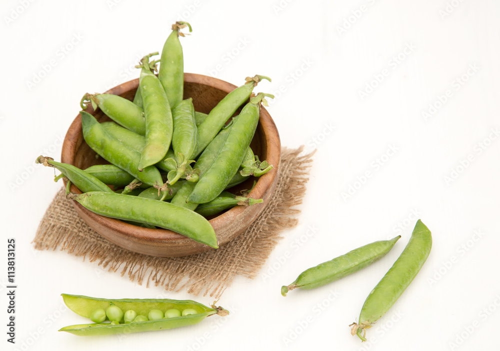 Green pea in bowl on rustic wooden background Green pea in bowl on rustic wooden background