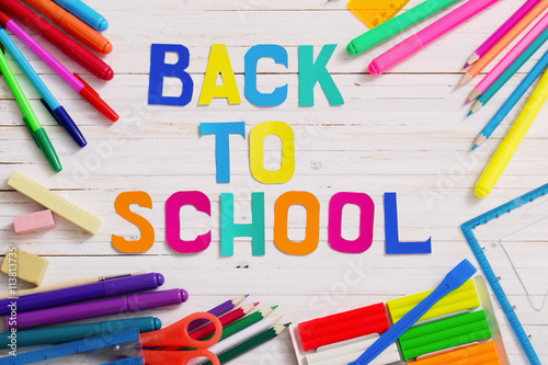 Back to school composition on white wooden background