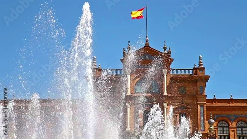 close up of the fountain at Plaza de Espana square in Seville city with main building and spanish flag, Andalusia, Spain