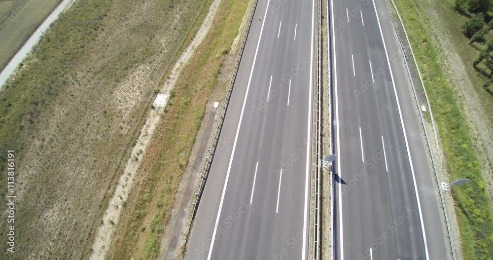 Aerial view of cars driving along empty country road in Germany Aerial view of cars driving along empty country road in Germany
