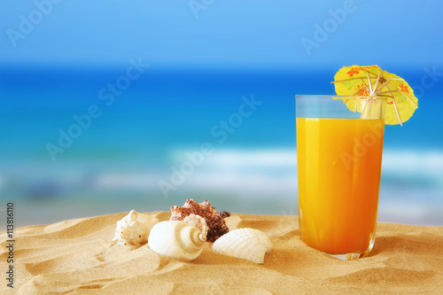 tropical sandy beach, fruit cocktail and seashells