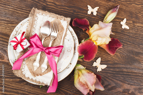 Tableware and silverware with irises photo