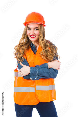 Young woman architect in an orange vest and helmet. Woman engineer in special clothes on a white background.