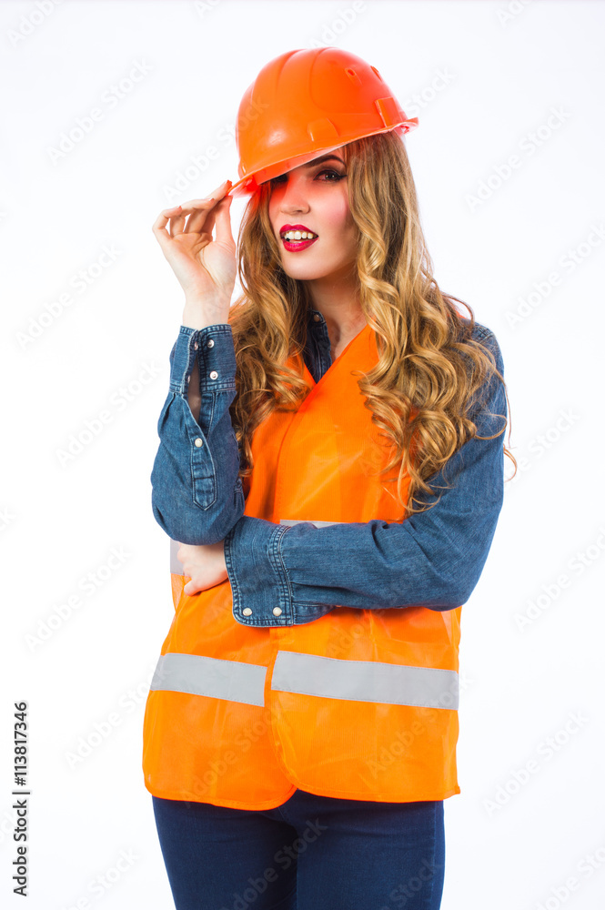 Young woman architect in an orange vest and helmet. Woman engineer in special clothes on a white background. Young woman architect in an orange vest and helmet. Woman engineer in special clothes on a white background.