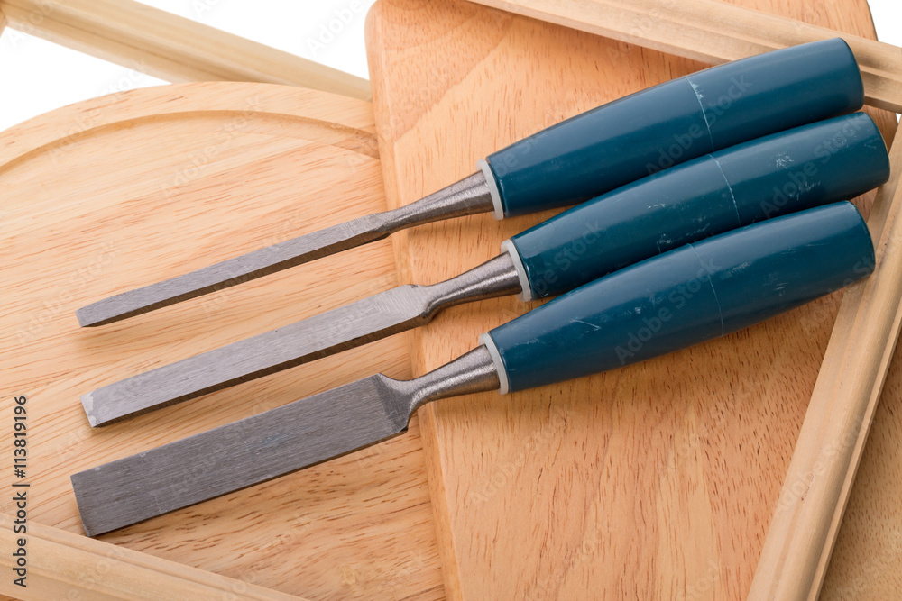 Three chisels on wood