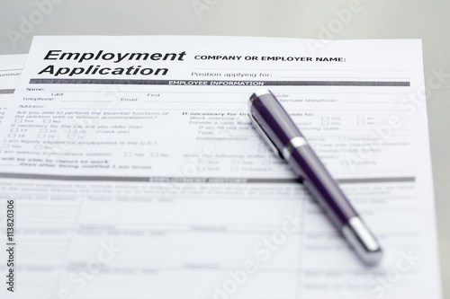 Employment Application information with pen. job vacancy concept or business employment concept.