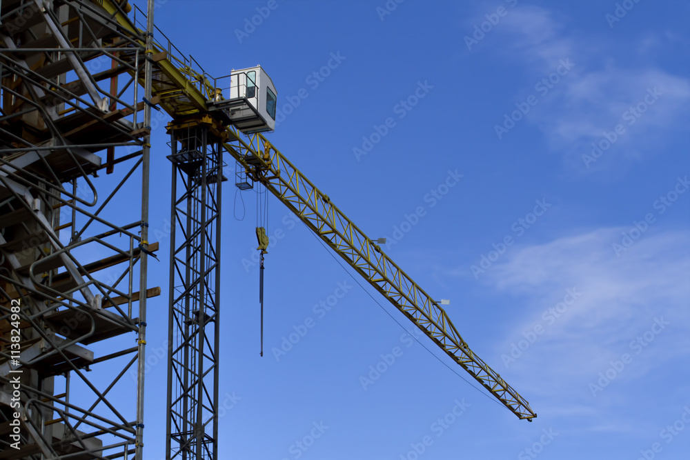 Construction site with crane on sky background. Low angle view.