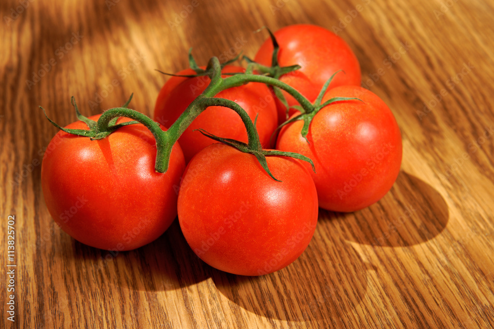 Tomato, bunch of vegetables on a wooden table Tomato, bunch of vegetables on a wooden table