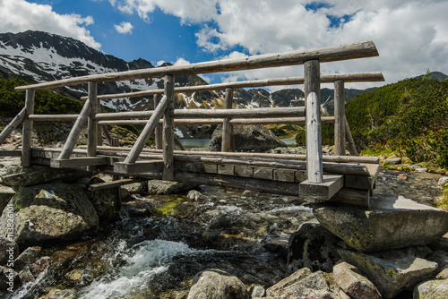 wooden bridge over alpine lake in Tatra mountains