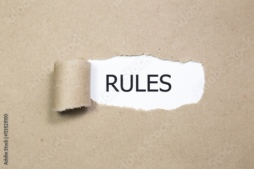 Fotografie rules message written under torn black paper