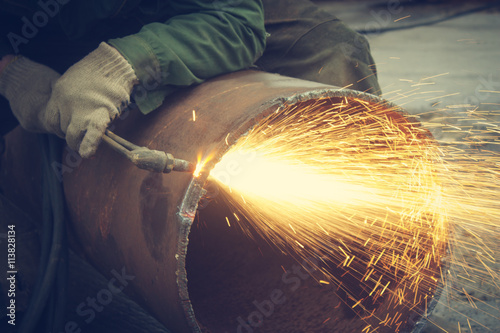 Metal cutting with acetylene torch.
