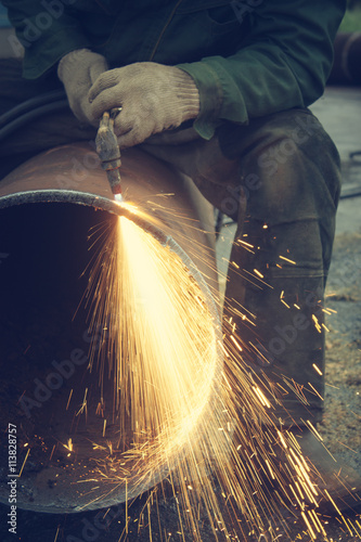 Metal cutting with acetylene torch.