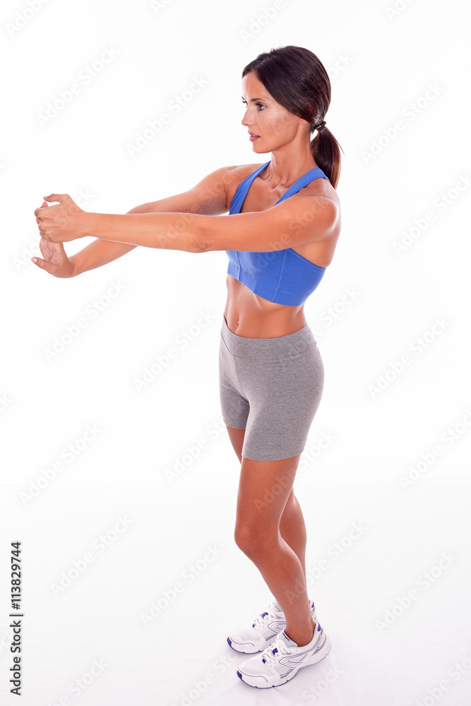 Stretching brunette woman on white backgound Stretching brunette woman on white backgound