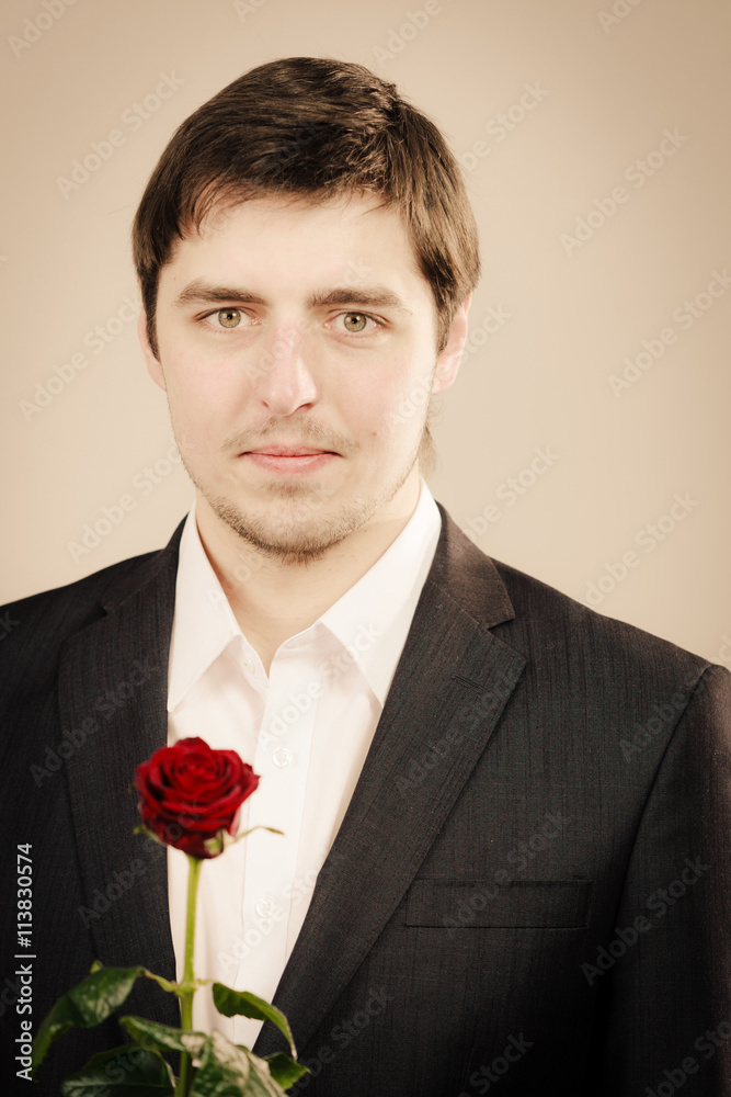 Handsome man with rose - obrazy, fototapety, plakaty 