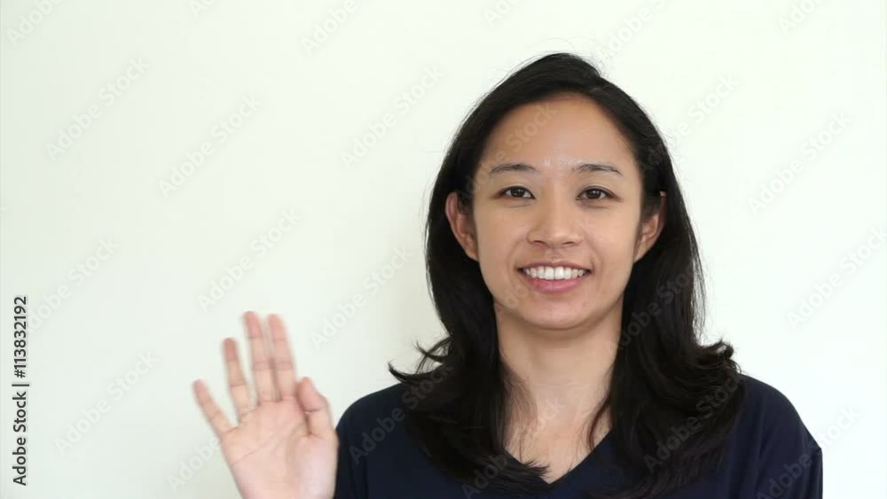 Casual asian girl on white background smiling face waving hands with relax tee shirt
Casual asian girl on white background smiling face waving hands with relax tee shirt