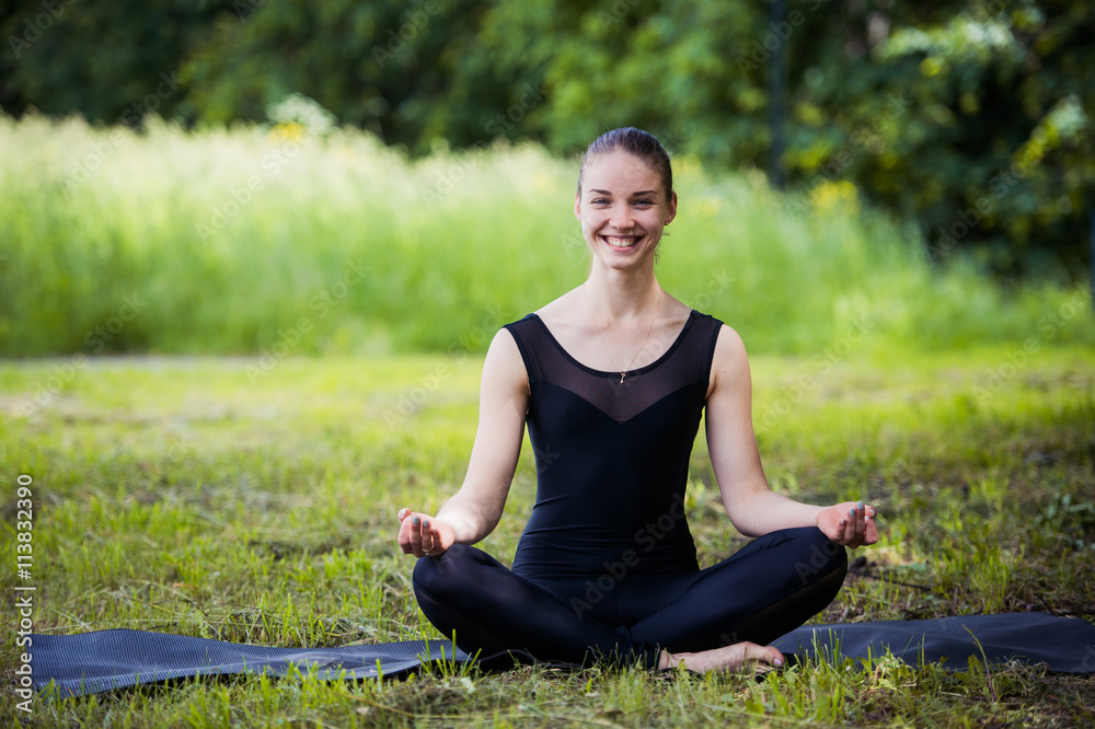 yoga woman on green grass in lotus pose smiling yoga woman on green grass in lotus pose smiling