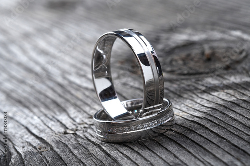 Konstfotografi Two wedding rings on rustic wood, b&w