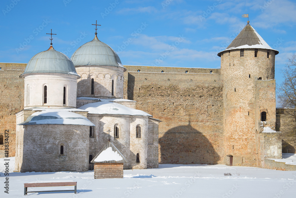 Tower and temple in Ivangorod fortress, sunny march day. Leningrad region, Russia