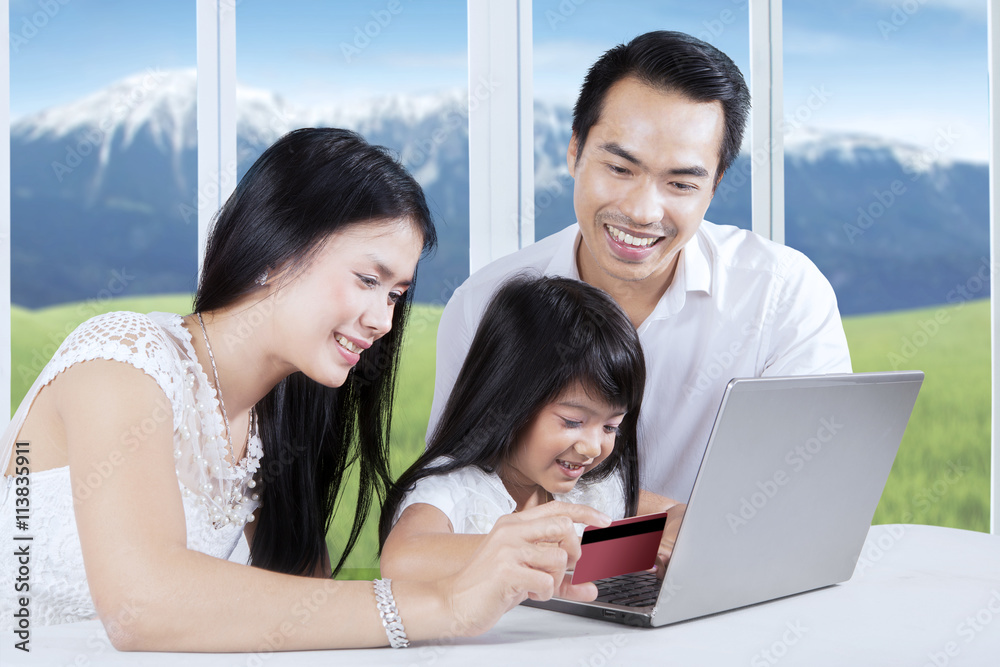 Family paying online with credit card Family paying online with credit card