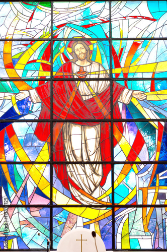 Detail of a modern colorful stained glass window with Jesus Christ and Sacred Heart, Divine Mercy photo