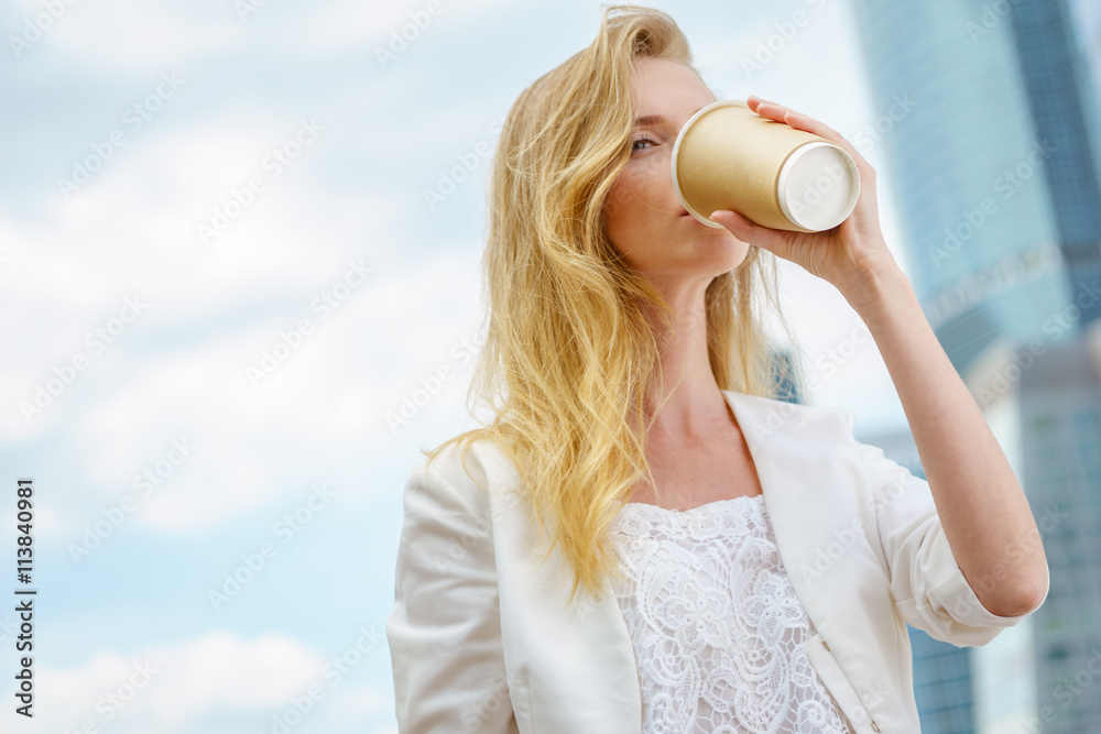 young girl in drinking coffee in the street young girl in drinking coffee in the street