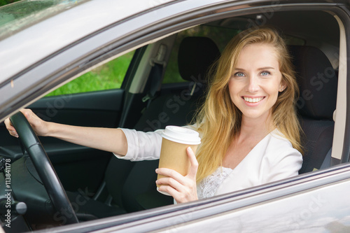 Smiling woman sitting in car