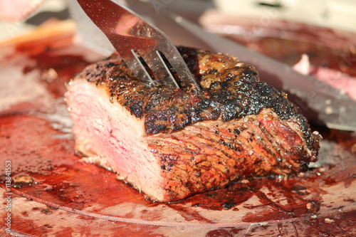 Cutting a freshly grilled prime beef steak